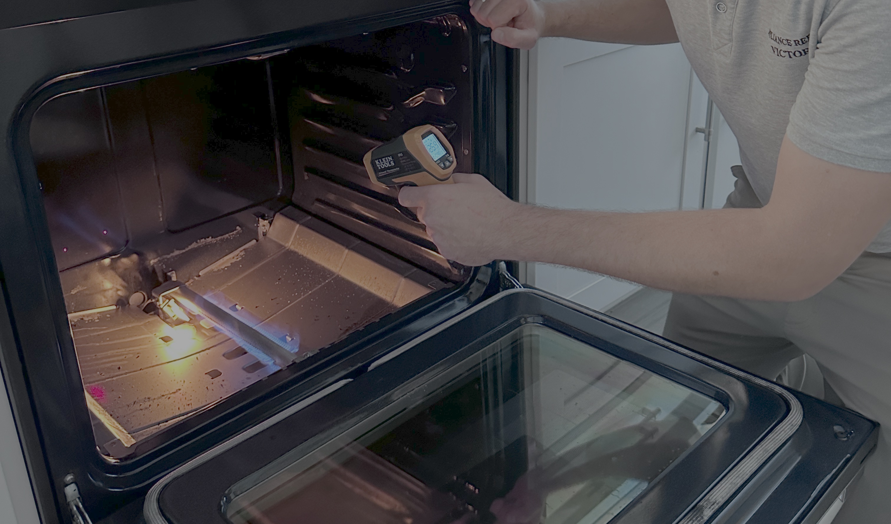 Easy Appliances Repair technician testing a range hood with a clamp meter in a Denver kitchen